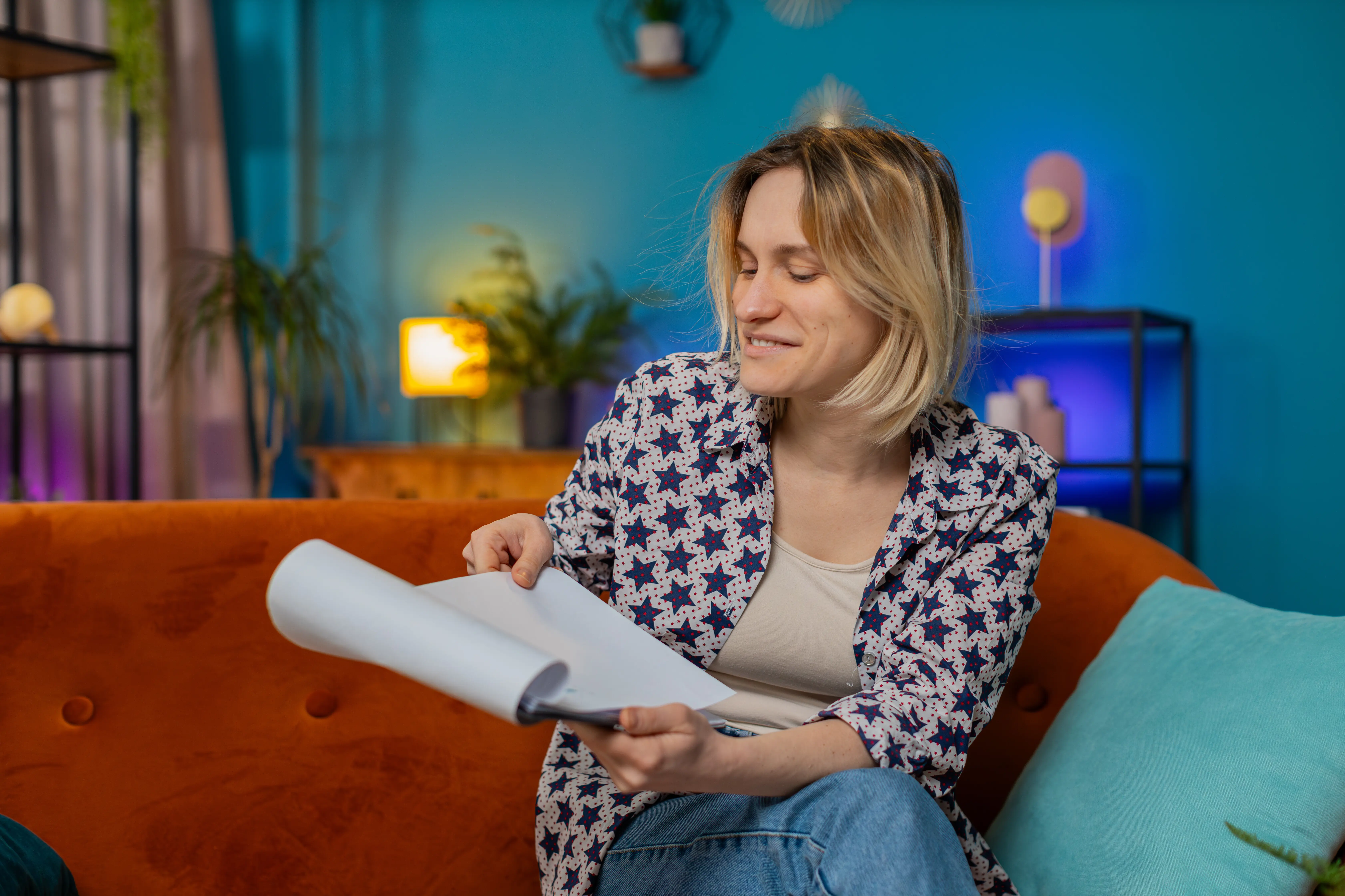 A woman freelancer working from home with documents, analyzing information and reading a business financial report.